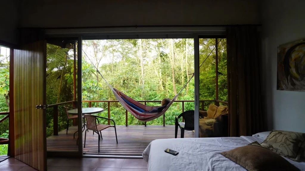 A cozy hammock inside an Amazon jungle lodge room, overlooking the lush rainforest in Ecuador.