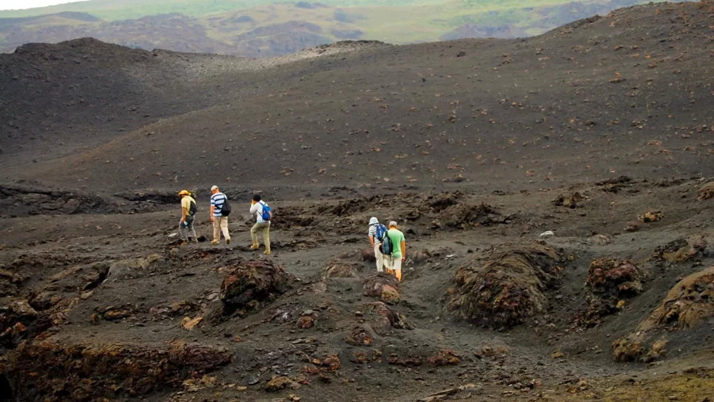Tourists exploring the massive crater of Sierra Negra volcano on Isabela Island, Galápagos. - US citizens travel Galapagos