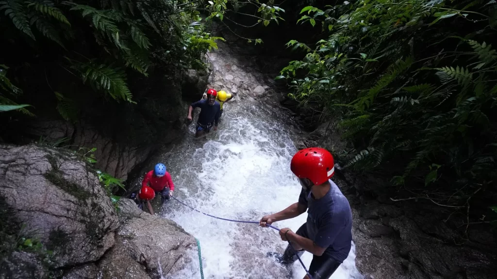 A person canyoning down a waterfall in Río Blanco, near Baños de Agua Santa, Ecuador.