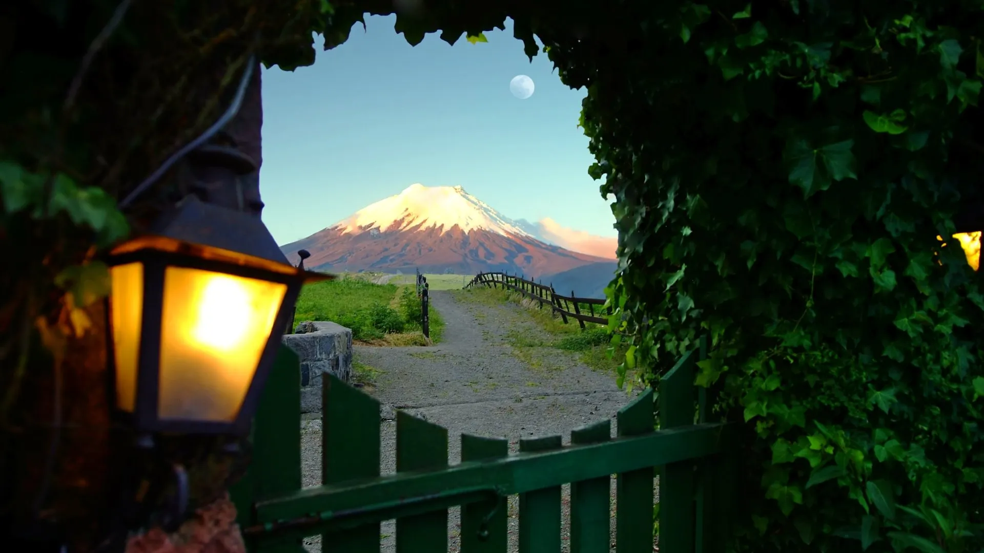 A view of Ecuador's active Cotopaxi Volcano framed by a rustic doorway in a natural setting.
