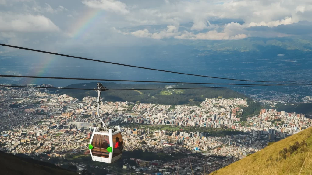 The TelefériQo cable car in Quito, Ecuador, ascending over the city with views of the Andes mountains.