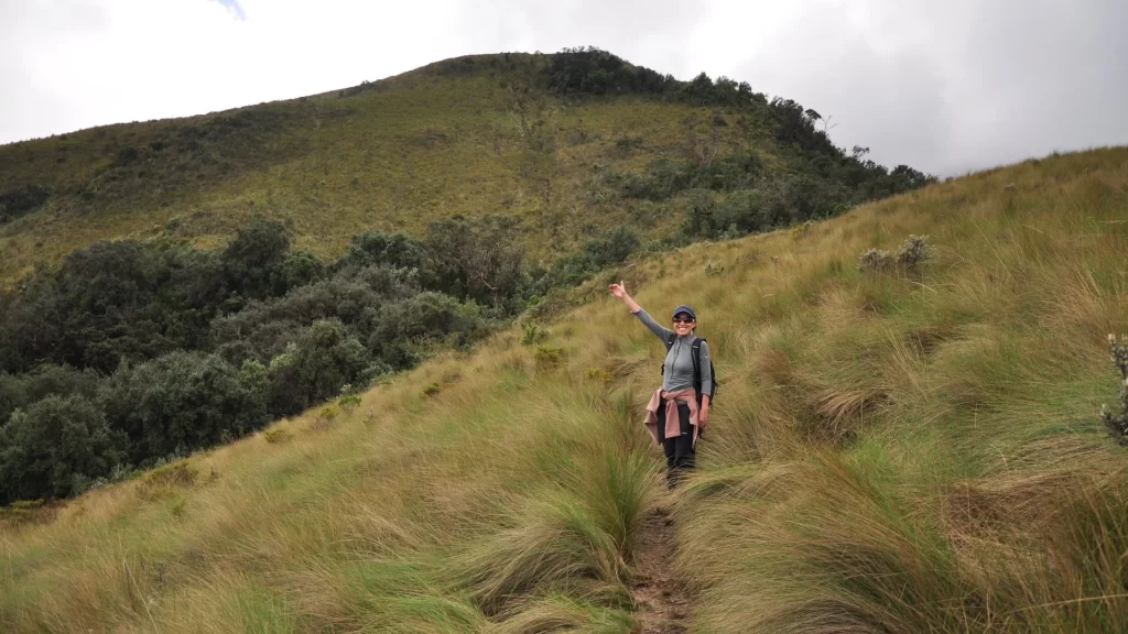 View of the Pasochoa volcano with a hiker enjoying the landscape-Trekking in Ecuador