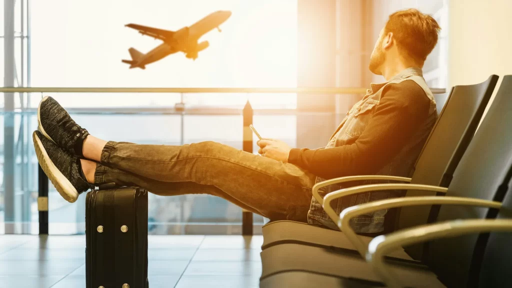 Traveler waits excitedly as he watches a plane take off, ready to explore new destinations-flights from the US to the Galápagos