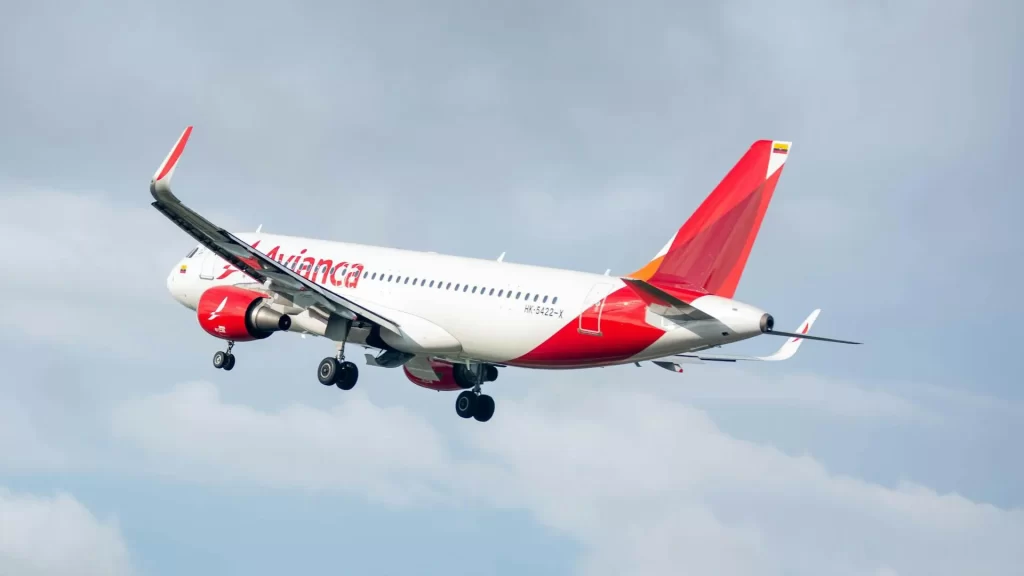Avianca aircraft in flight under a blue sky.