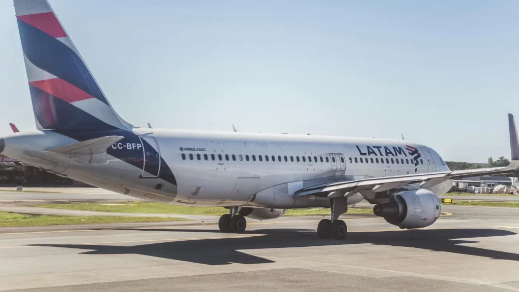 LATAM Airlines Airbus A320 on the runway at an airport.
