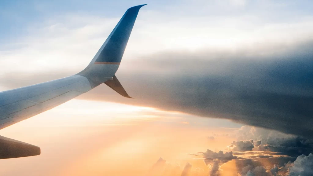 Close-up view of an airplane tail against a clear blue sky.