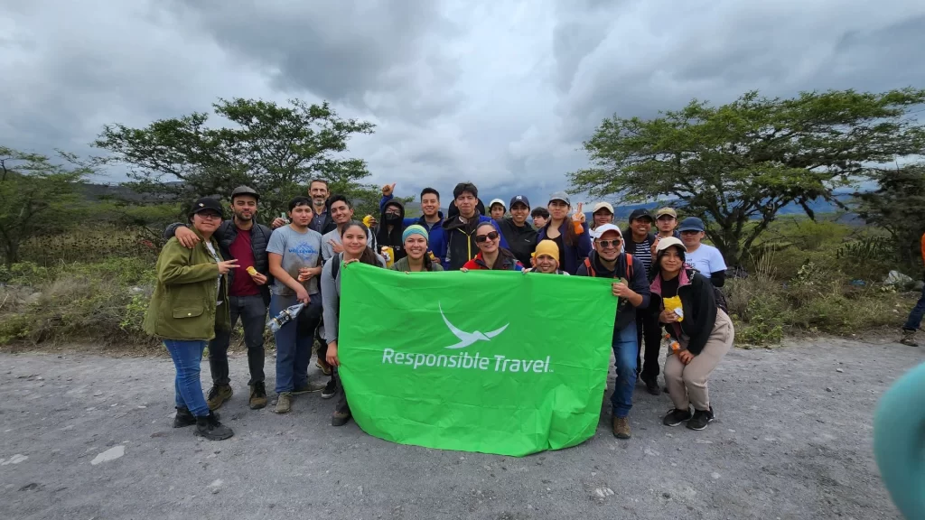 Responsible Travel employees pose with the company logo-Amazon lodges