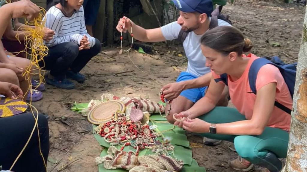 Tourists interacting with local artisans in a rural Amazonian community in Ecuador.
