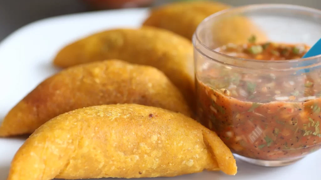 Golden, crispy empanadas served with homemade chili sauce-Colombian Gastronomy