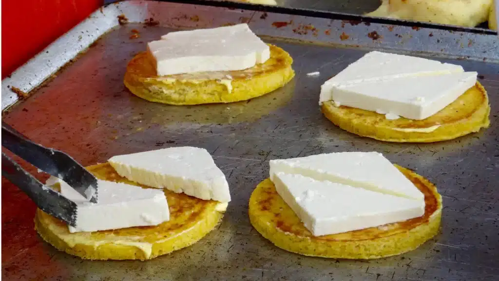 Freshly made corn arepas topped with fresh cheese-Colombian Gastronomy