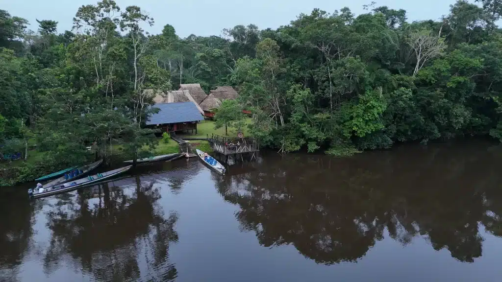 Wooden facade and common areas of Waita Lodge, a cozy ecolodge in the heart of the Cuyabeno Reserve.